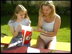 Two teen girls plays at the yard with toys